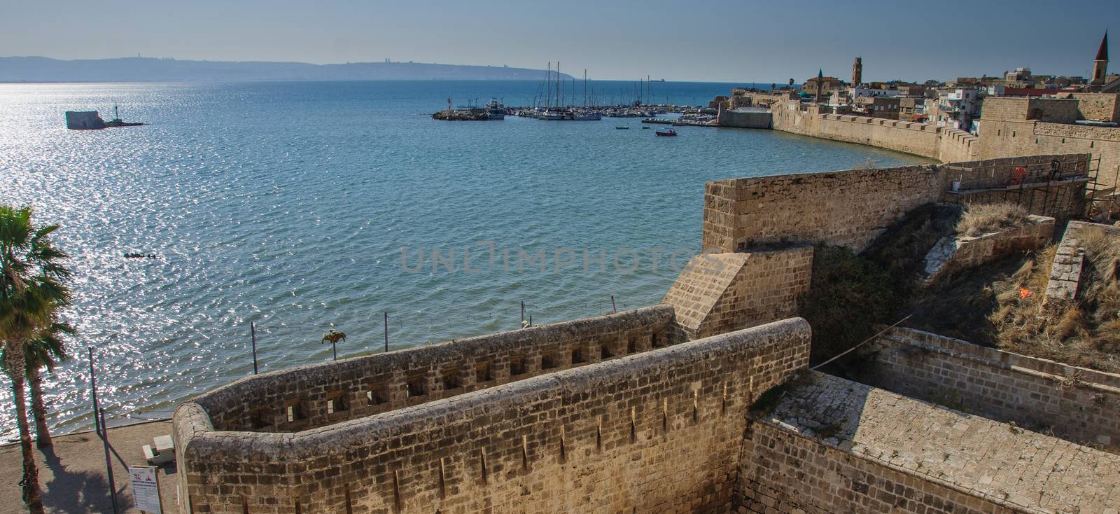 View of the city walls and the fishing harbor, the old city of Acre, Israel