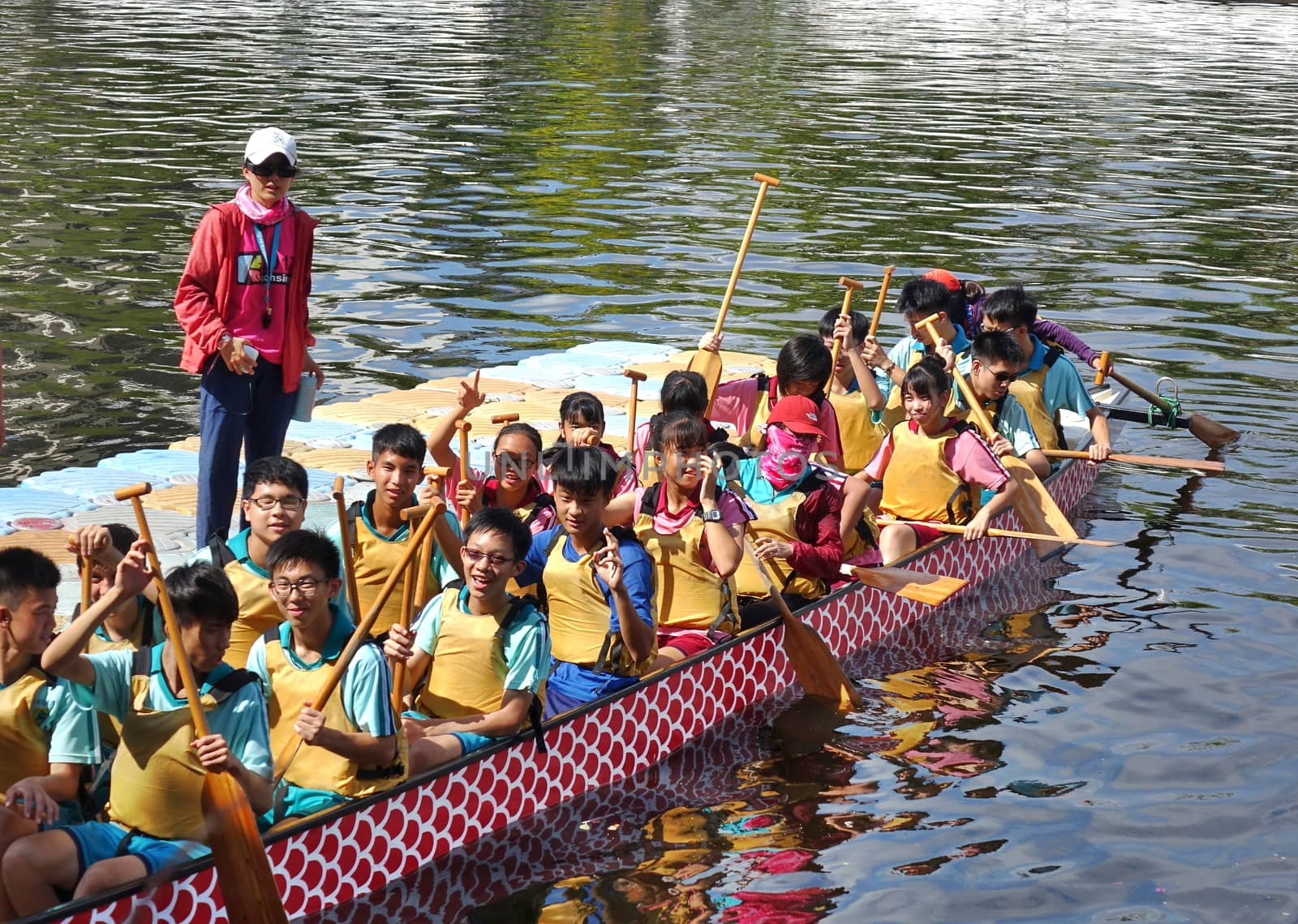 KAOHSIUNG, TAIWAN -- JUNE 10, 2018: A team of junior high school students prepares for the upcoming Dragon Boat Races.
