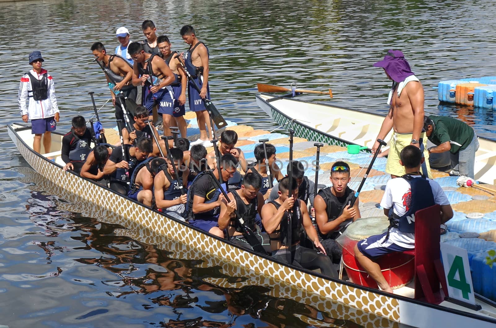 KAOHSIUNG, TAIWAN -- JUNE 10, 2018: A team of sailors from the navy prepares for the upcoming Dragon Boat Races.