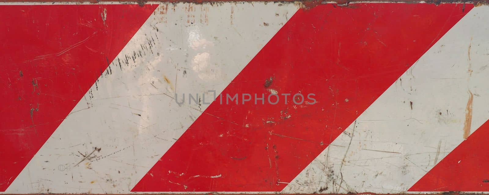 red and white striped metal traffic warning sign