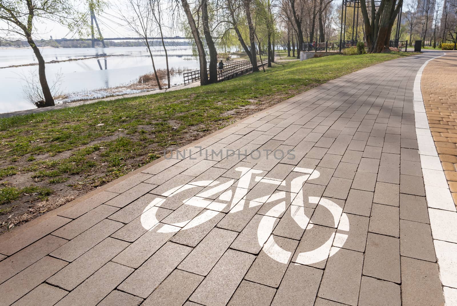 White bike path sign painted on a lane in the Natalka park of Kiev, Ukraine