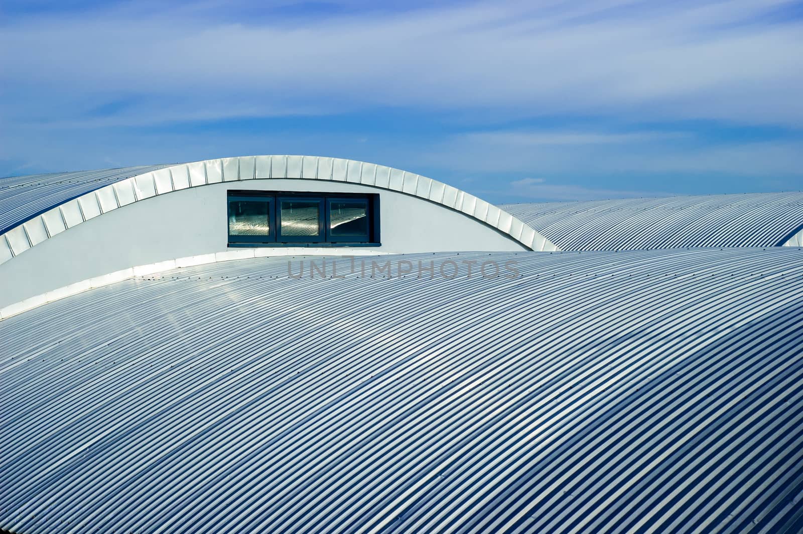 Metallic roof and blue sky with clouds