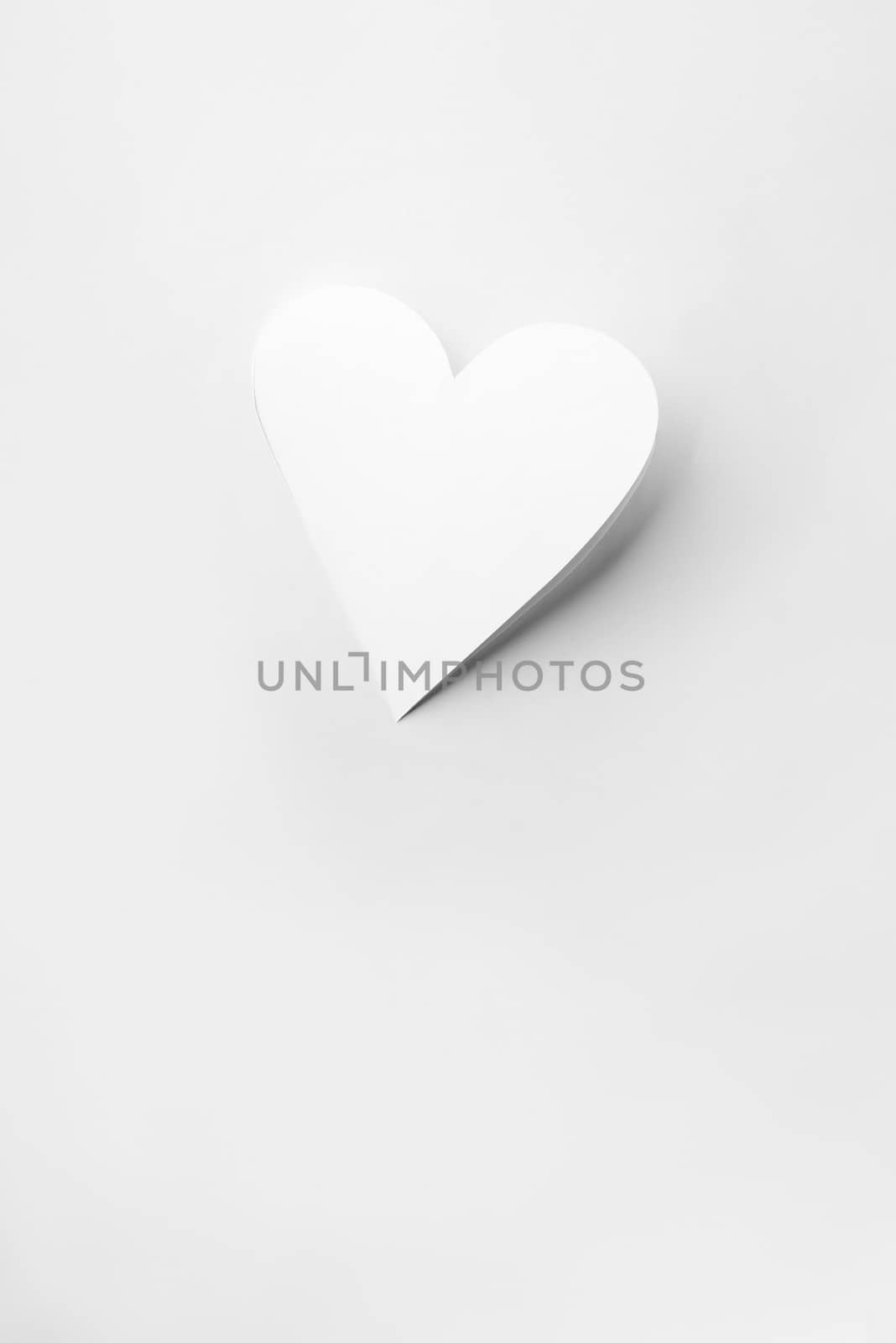 Real cutout white paper heart with shadow