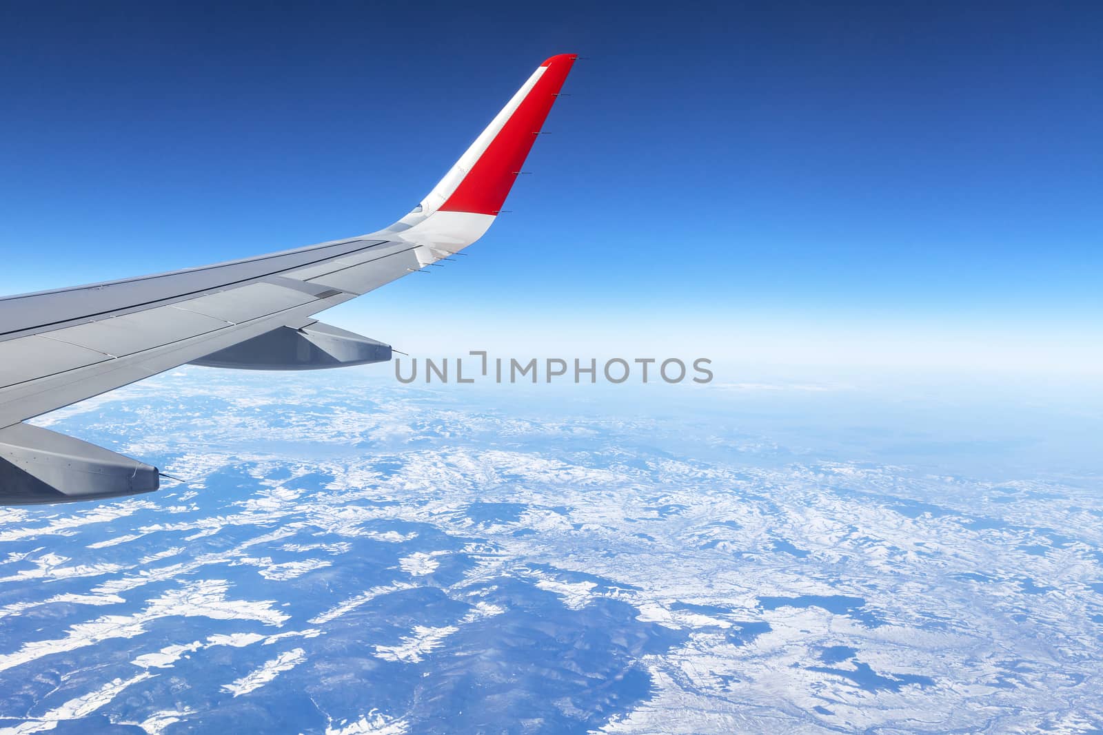 Wing of an airplane and the land below