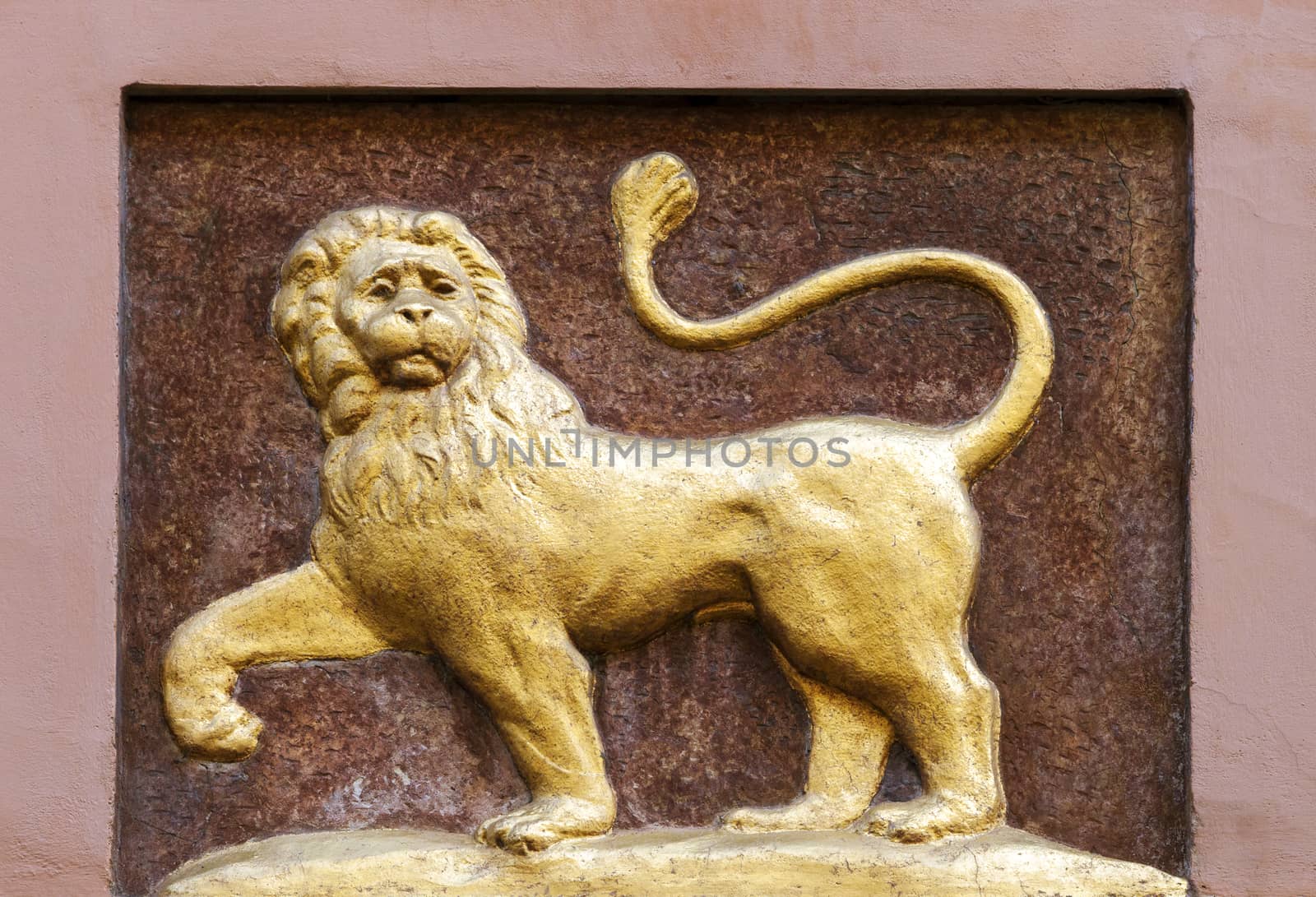 Golden lion relief on a wall in Prague, Czech Republic