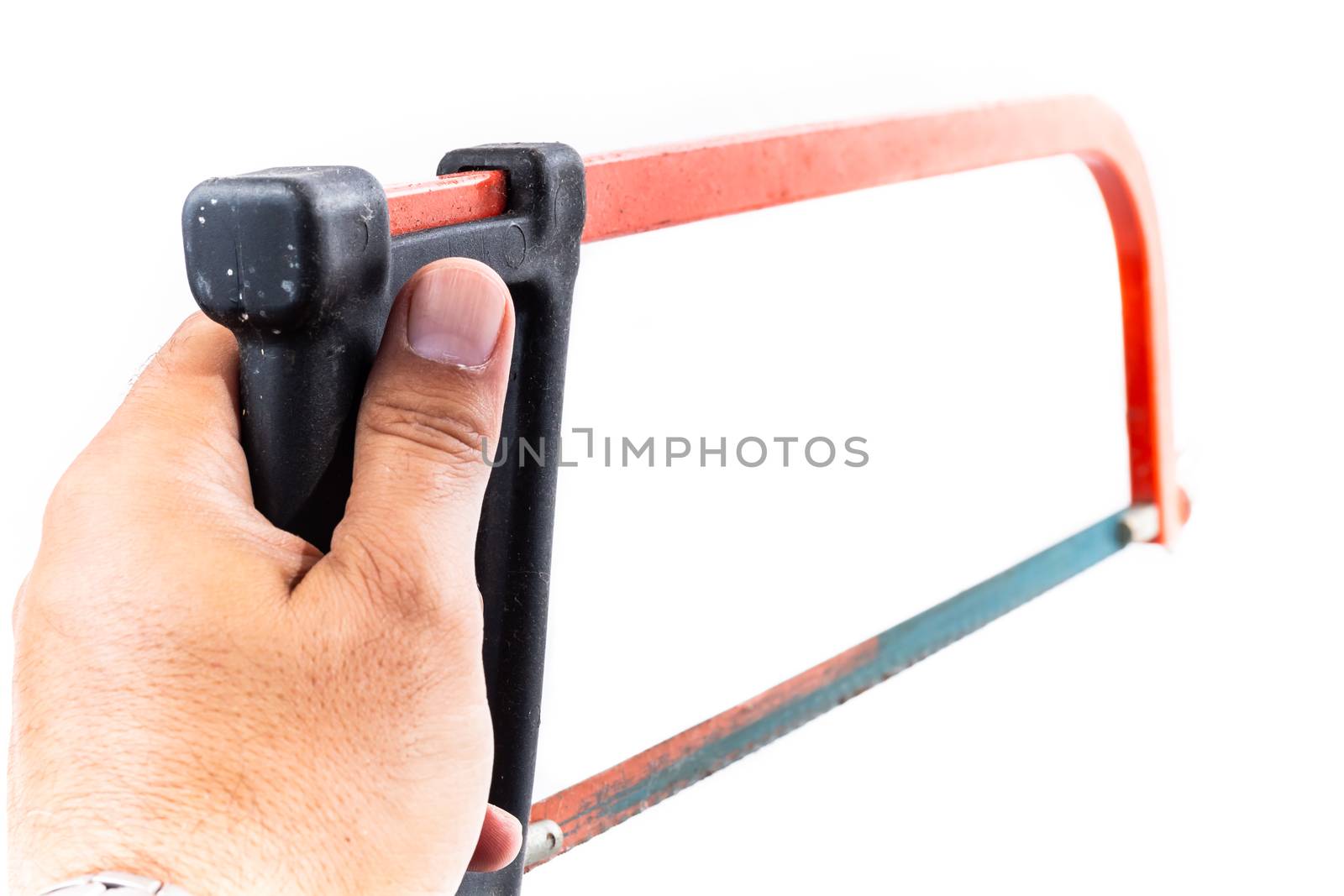 man who serves in his hand a rusty red hacksaw on a white background in studio