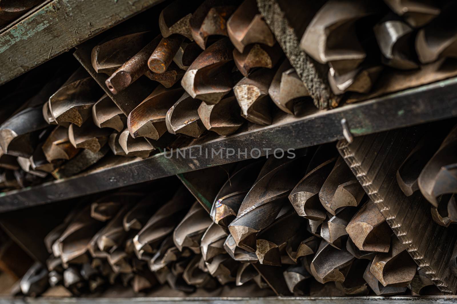 big rusted iron drills on the shelf by mkenwoo