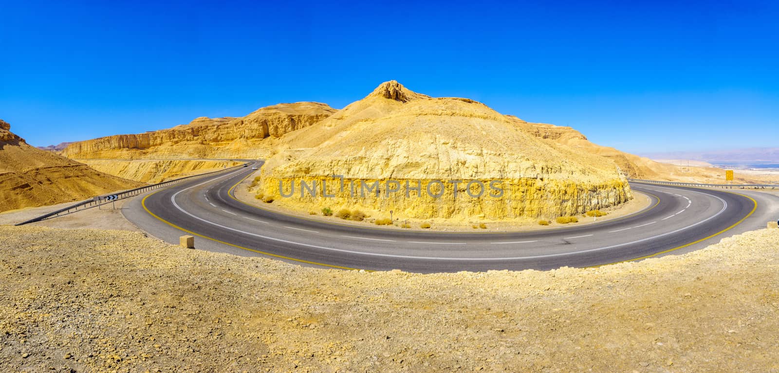 View of road 25 winding between the desert cliffs, in the northern Arava valley, southern Israel