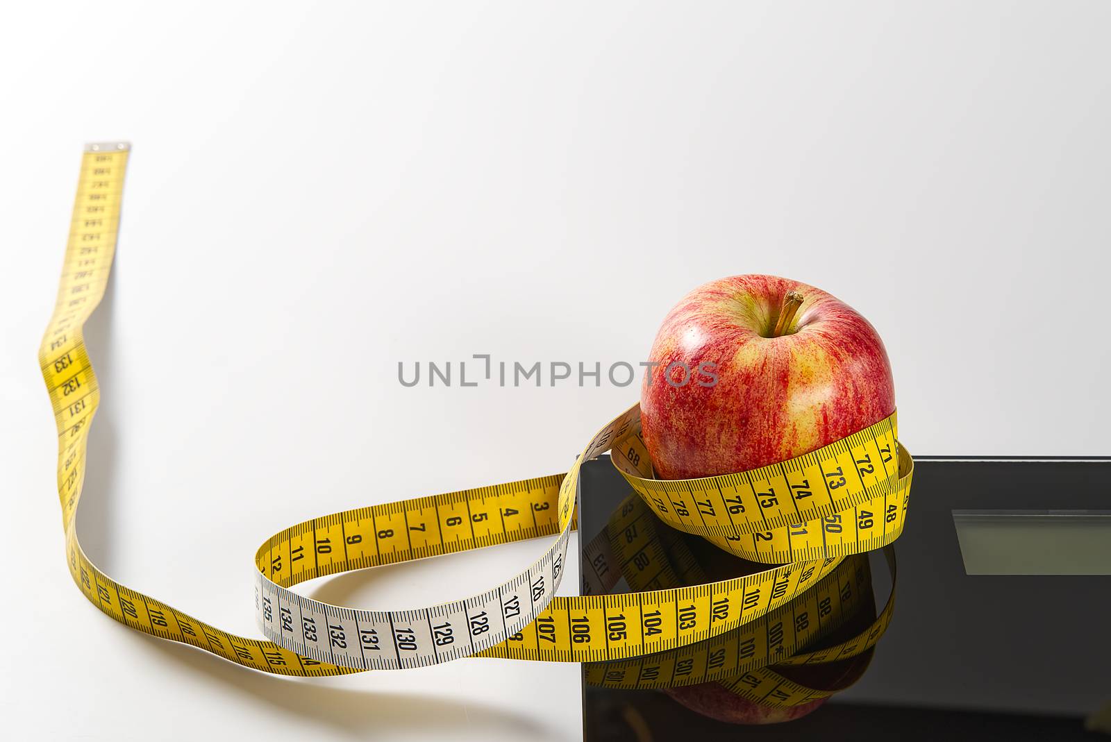 Diet plan, menu or program, tape measure, diet food of fresh fruits on white background, weight loss and detox concept, top view. weight loss concept. Apple and measuring tape. Diet. by PhotoTime