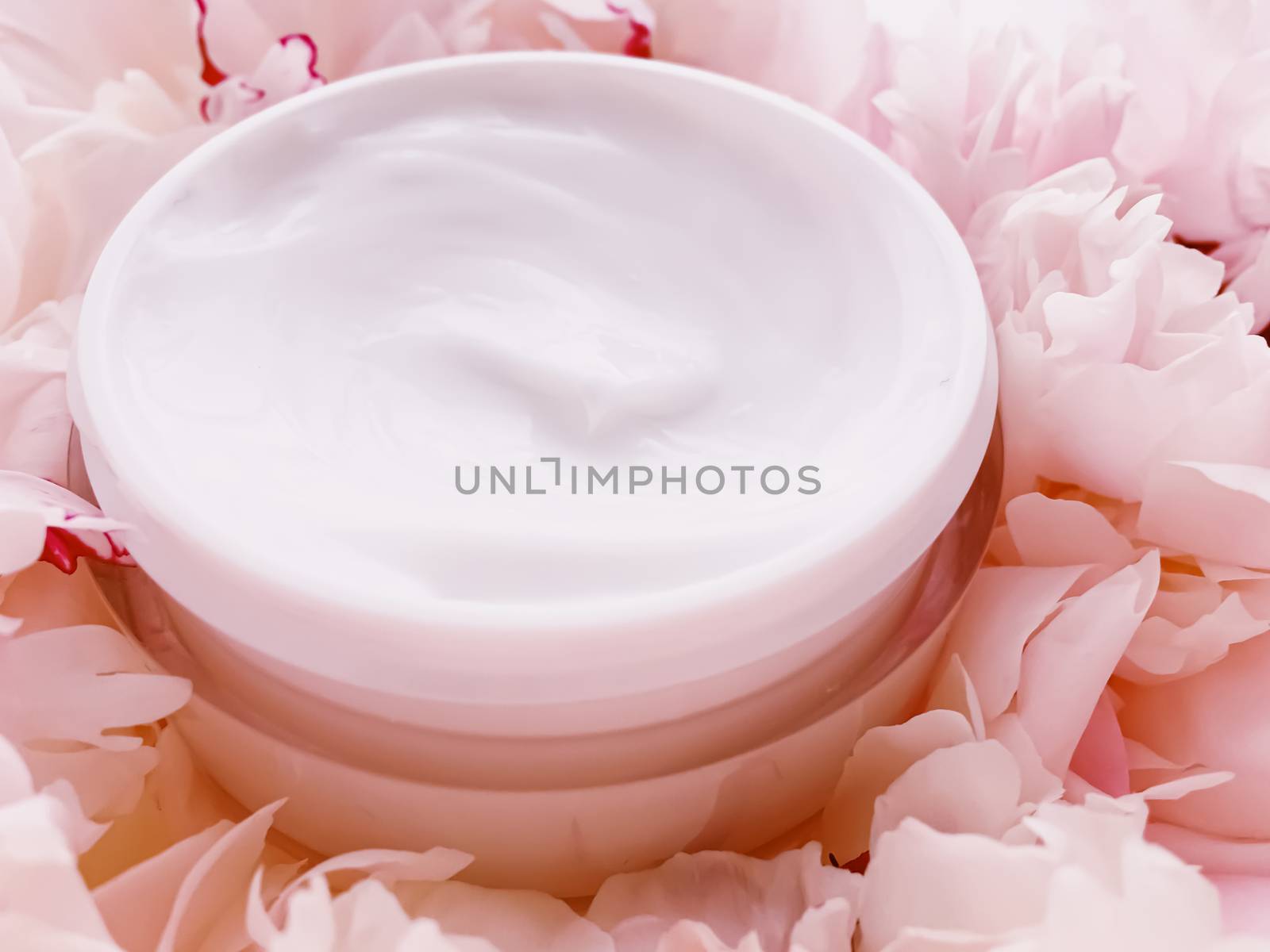 Face cream moisturizer on floral background as luxury skincare cosmetics, healthcare and beauty product concept