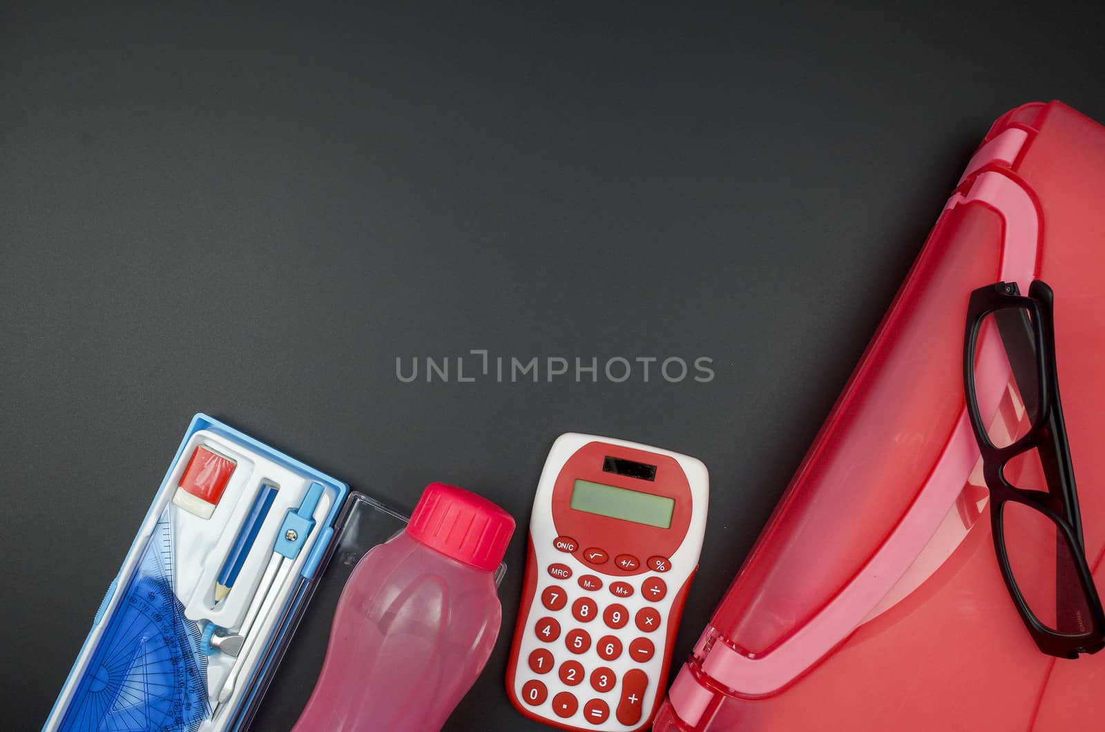 Various school supplies. studying, education and back to school concept. Black background and selective focus.