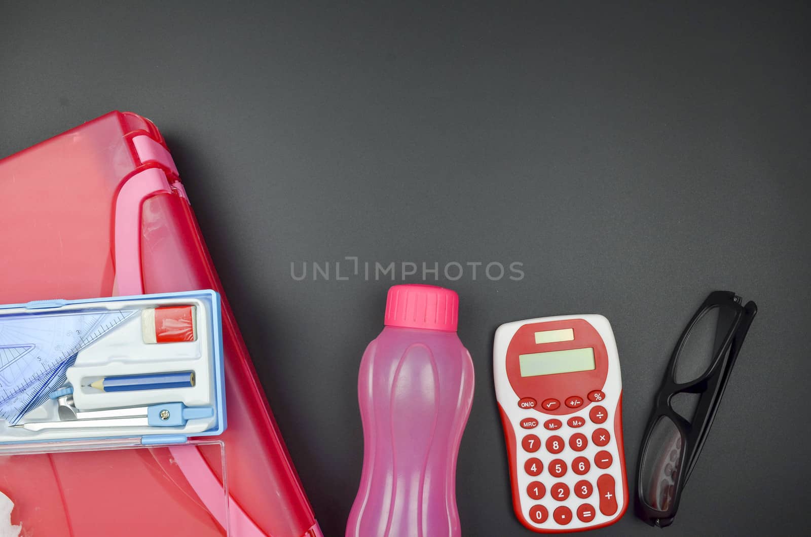 Various school supplies. studying, education and back to school concept. Black background and selective focus.