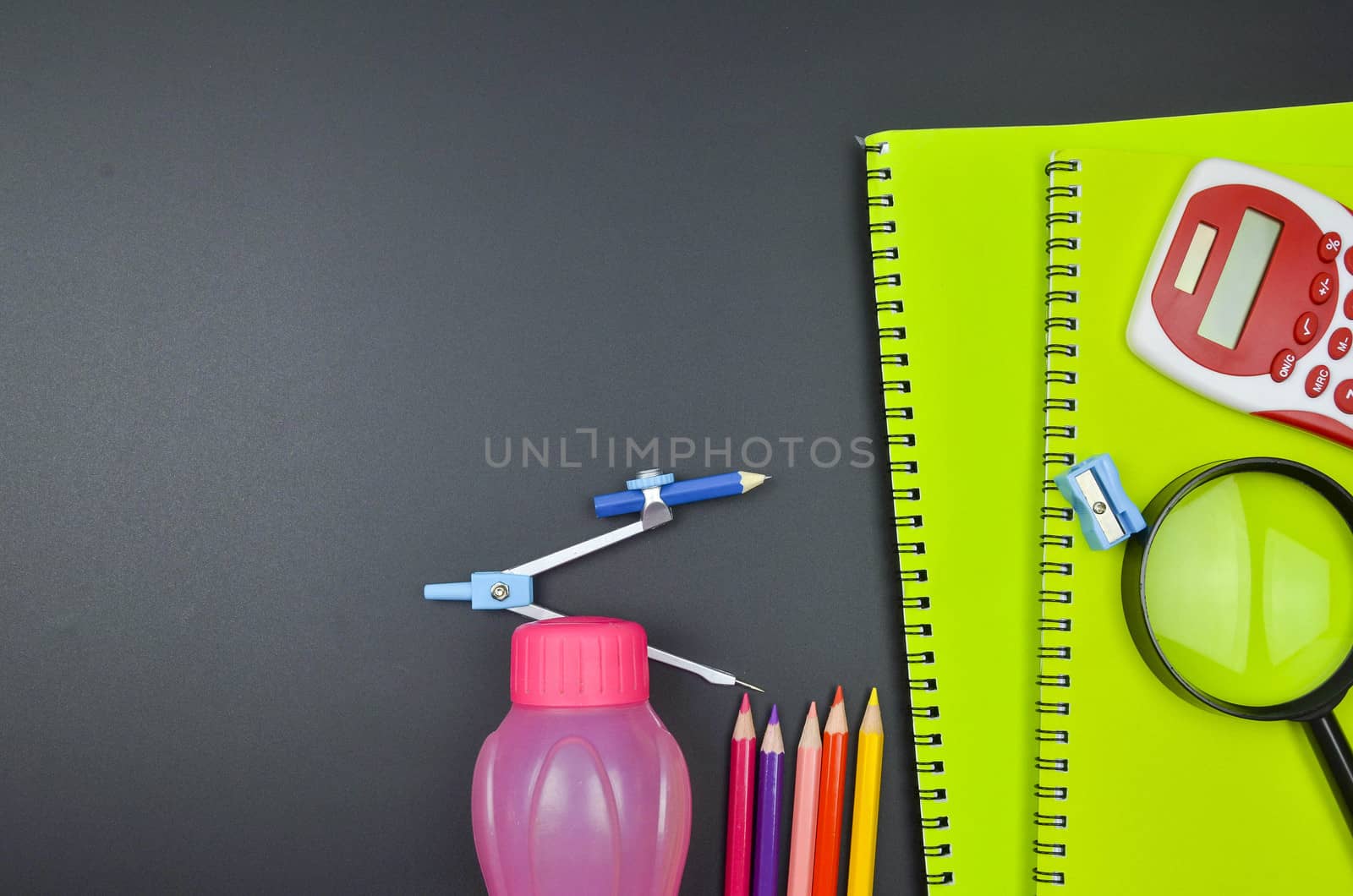 Various school supplies. studying, education and back to school concept. Black background and selective focus.