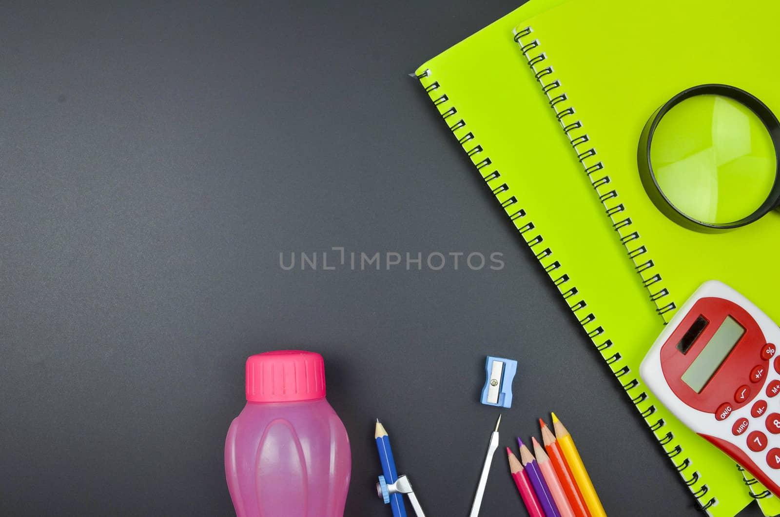 Various school supplies. studying, education and back to school concept. Black background and selective focus.