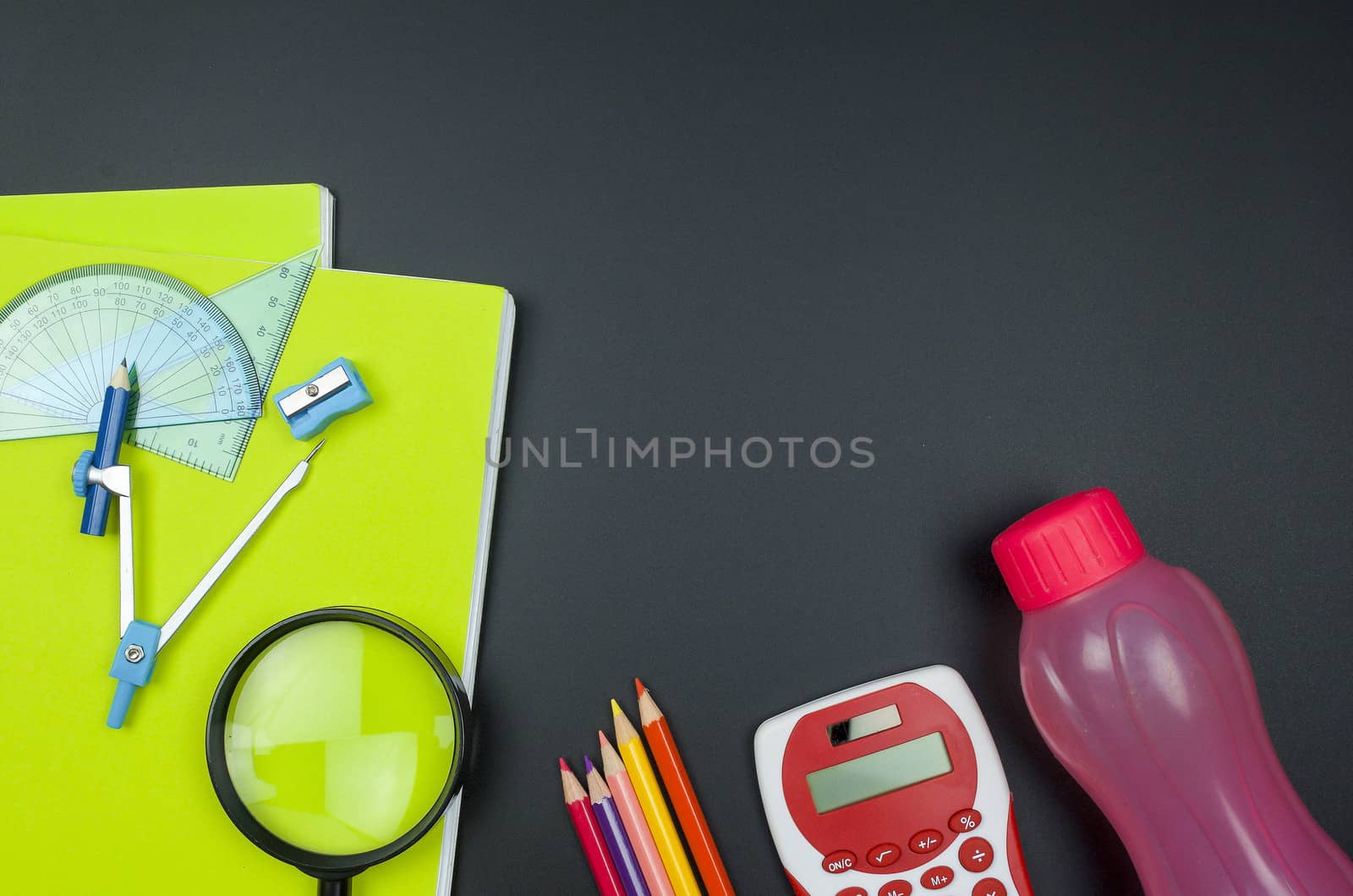 Various school supplies. studying, education and back to school concept. Black background and selective focus.