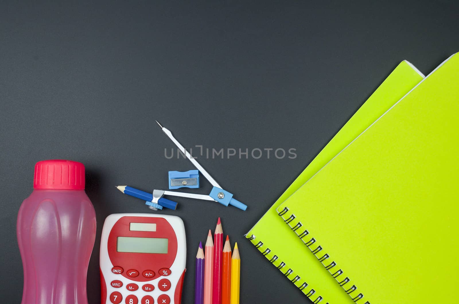 Various school supplies. studying, education and back to school concept. Black background and selective focus.