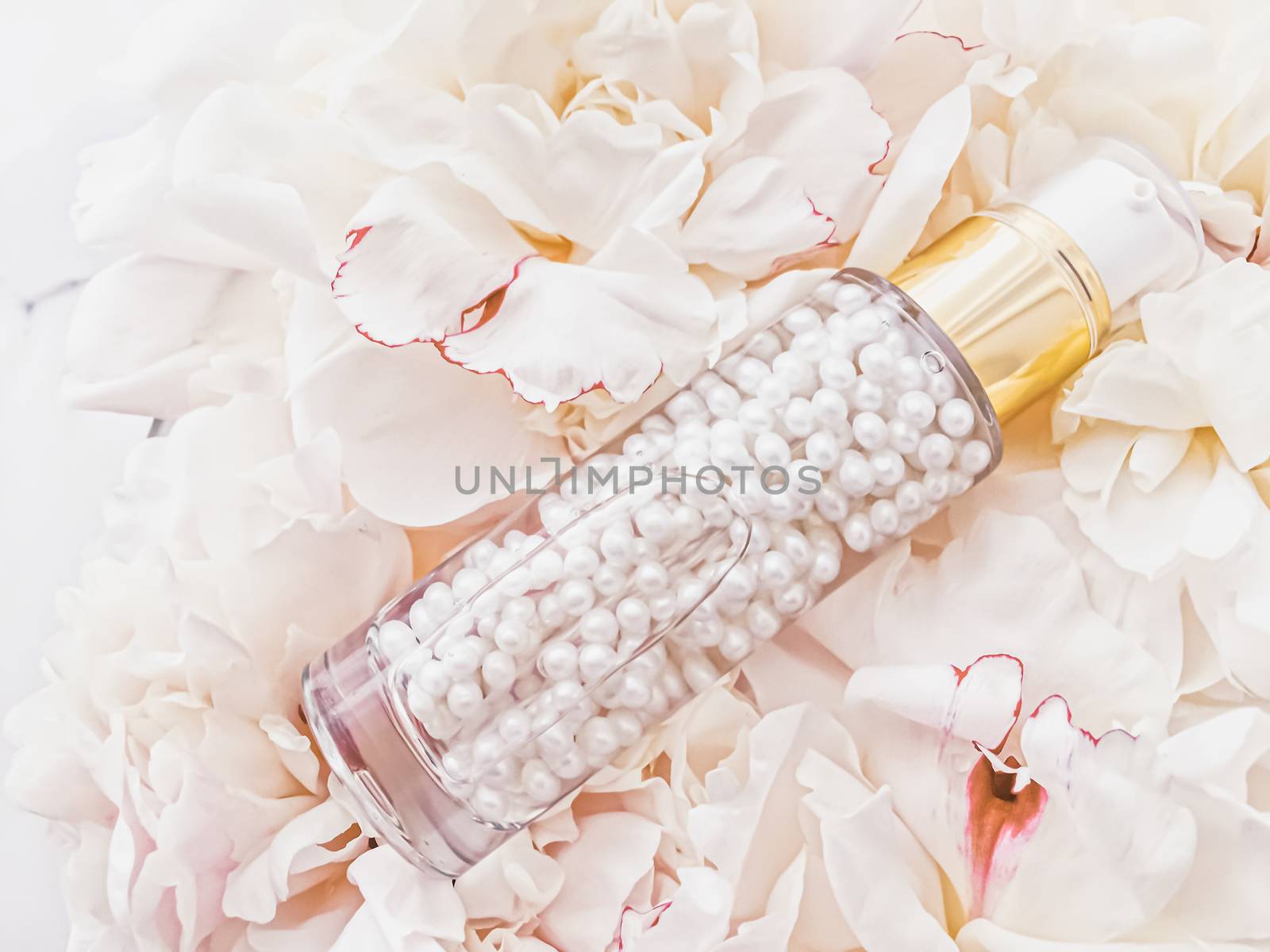 Luxurious cosmetic bottle as antiaging skincare product on background of flowers, blank label packaging for body care branding design