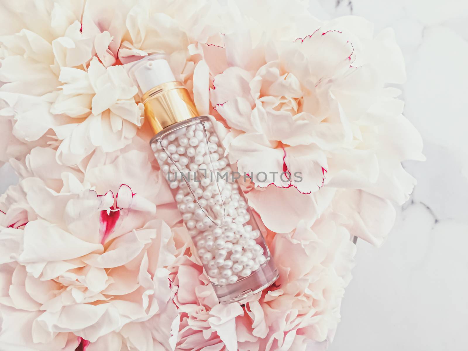 Luxurious cosmetic bottle as antiaging skincare product on background of flowers, blank label packaging for body care branding design