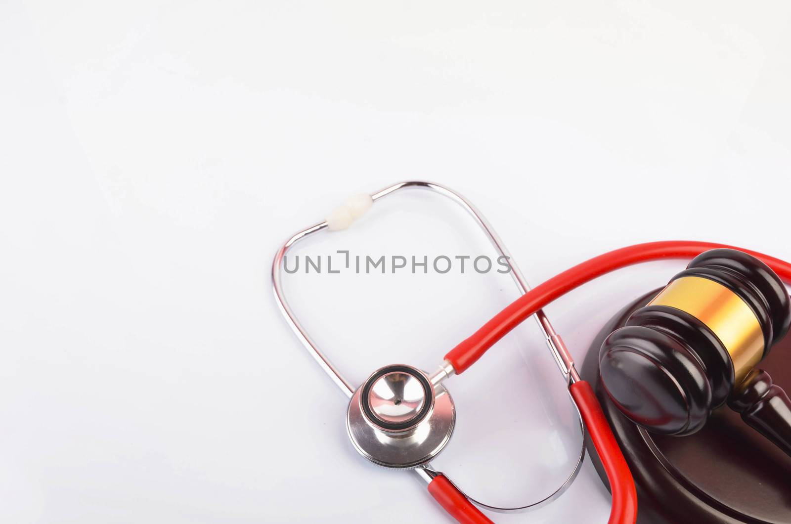 Judge hammer or gavel with stethoscope on white background. Justice and law concept. Selective focus.