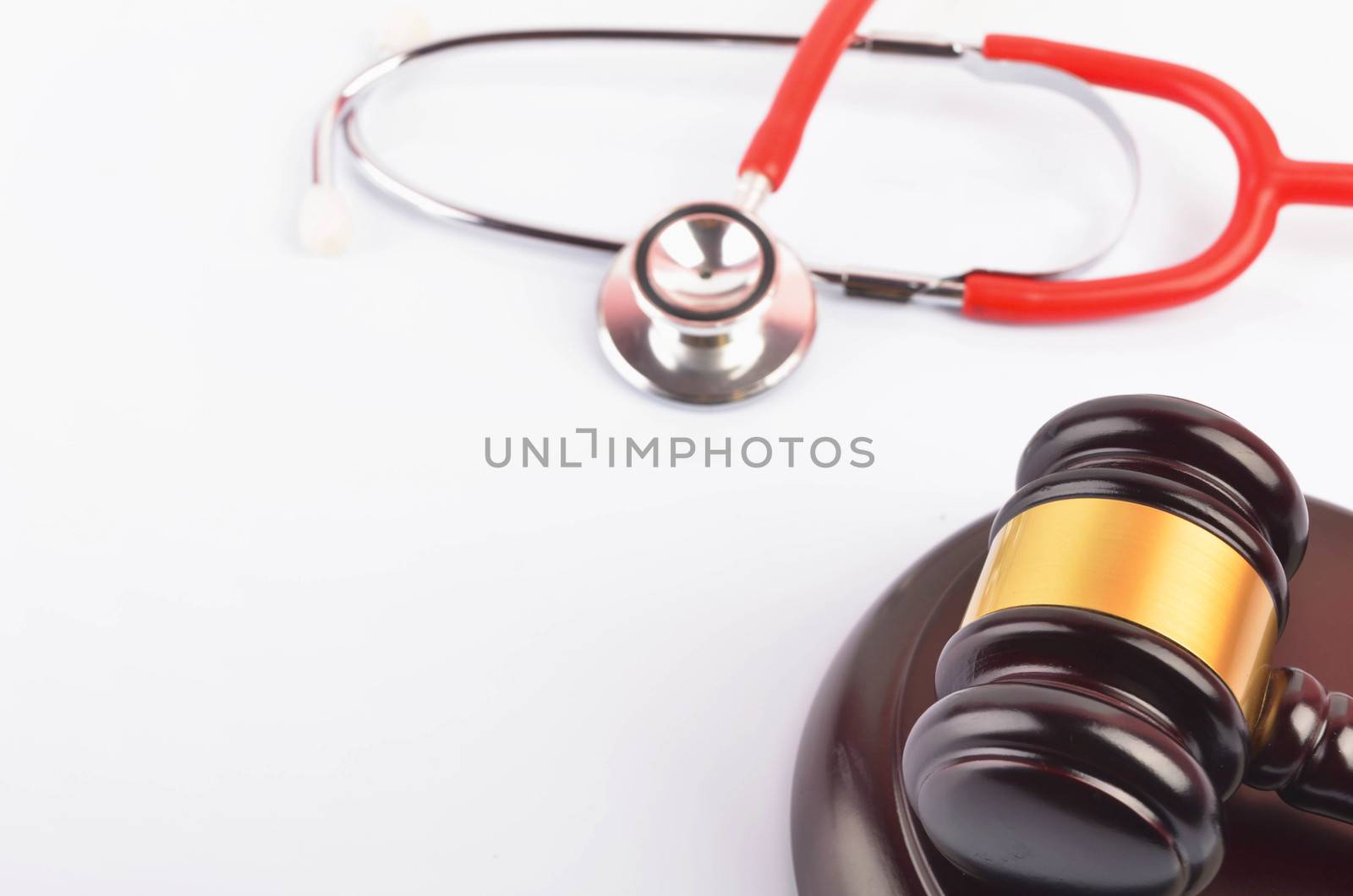 Judge hammer or gavel with stethoscope on white background. Justice and law concept. Selective focus.