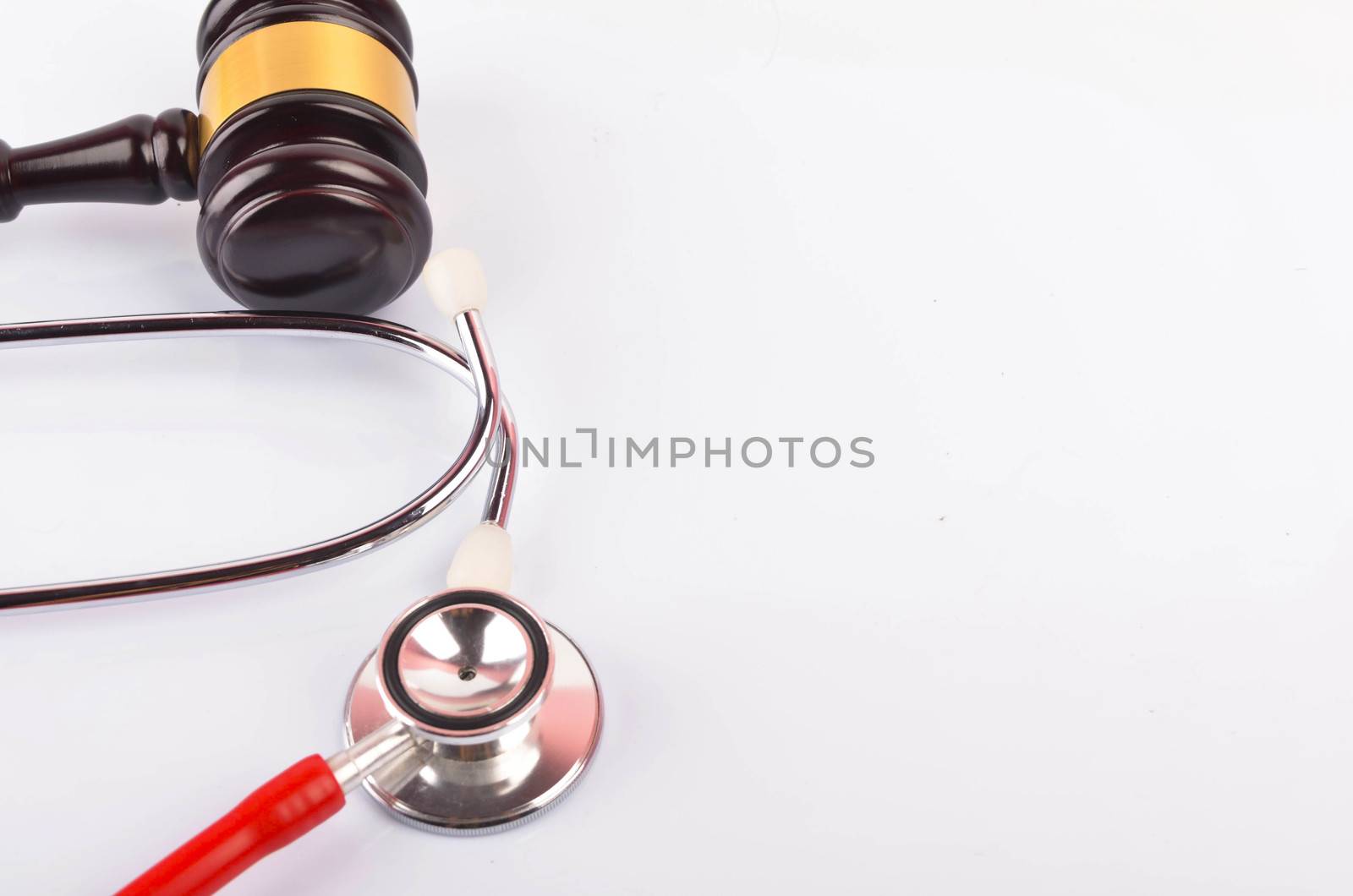 Judge hammer or gavel with stethoscope on white background. Justice and law concept. Selective focus.