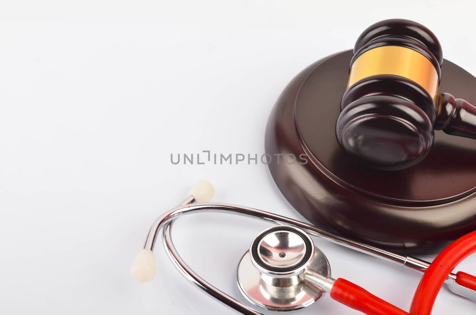 Judge hammer or gavel with stethoscope on white background. Justice and law concept. Selective focus.