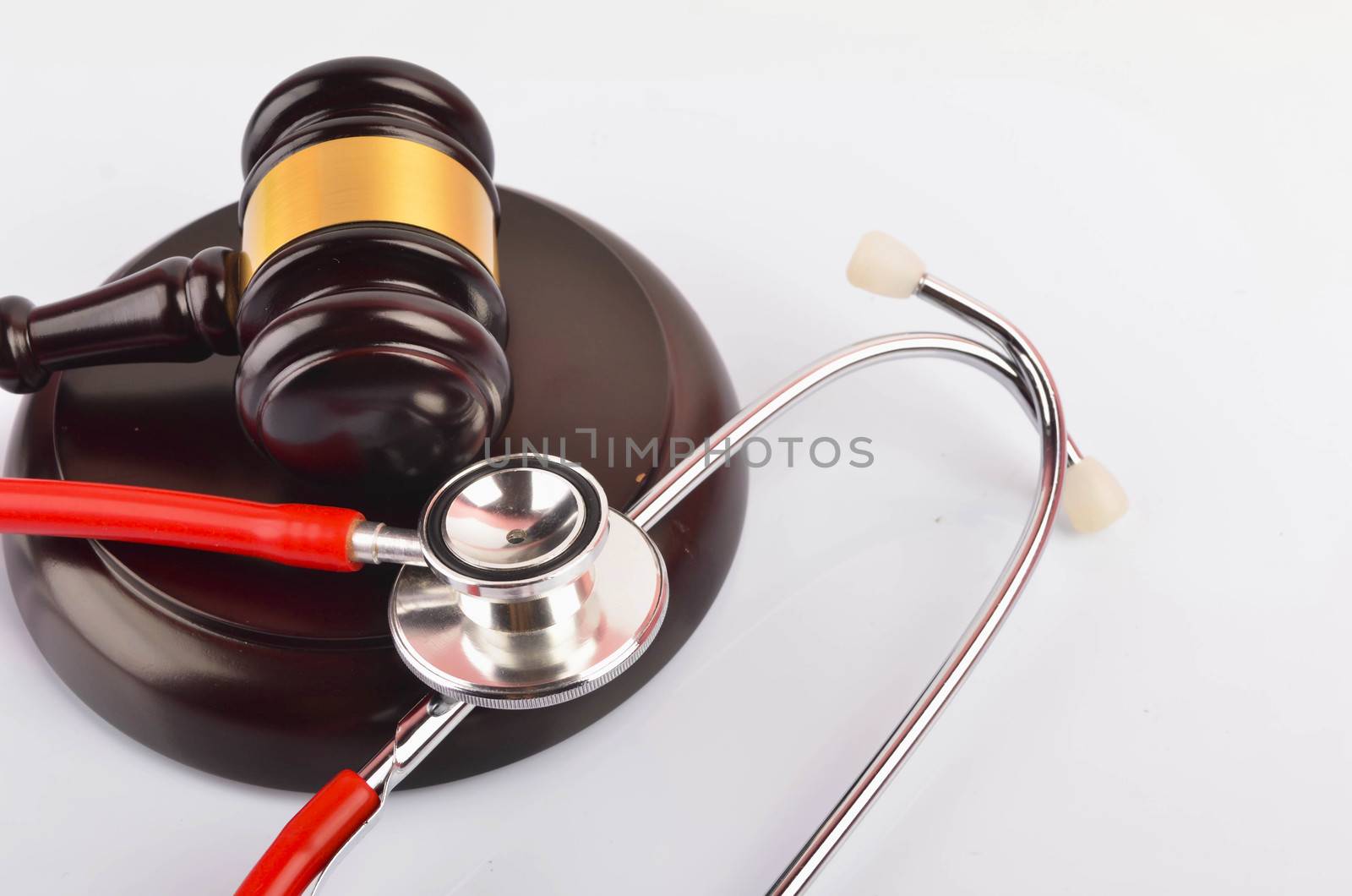 Judge hammer or gavel with stethoscope on white background. Justice and law concept. Selective focus.