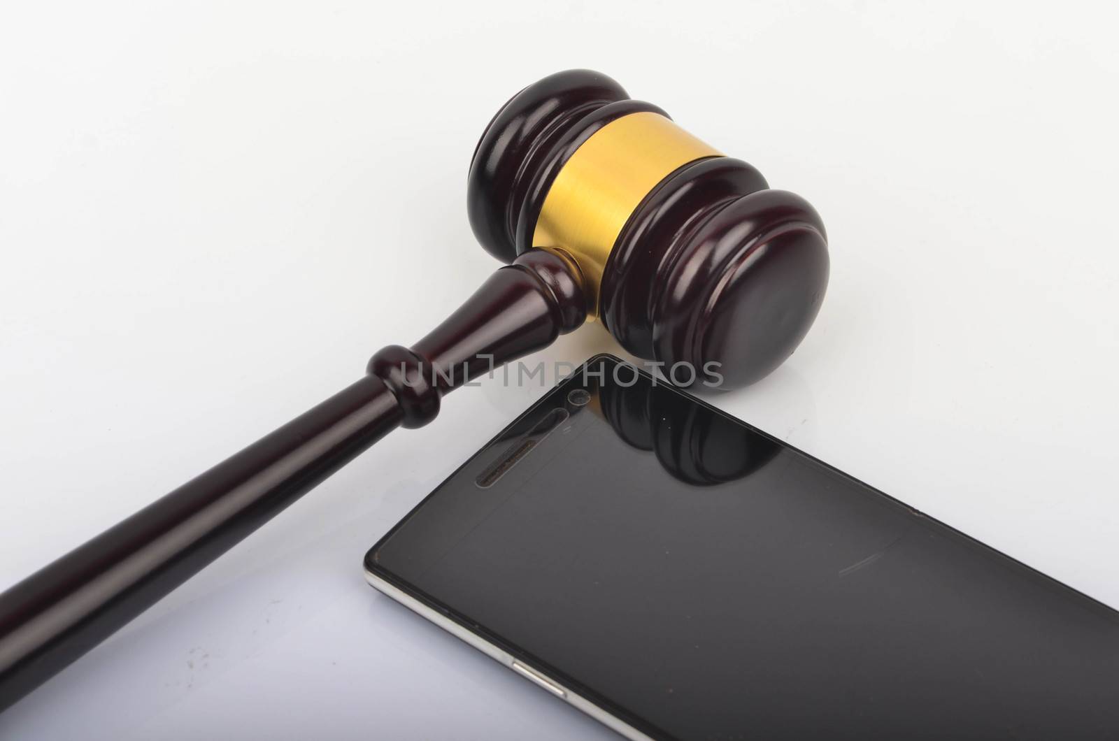 Judge hammer or gavel with smartphone on white background. Justice and law concept. Selective focus.