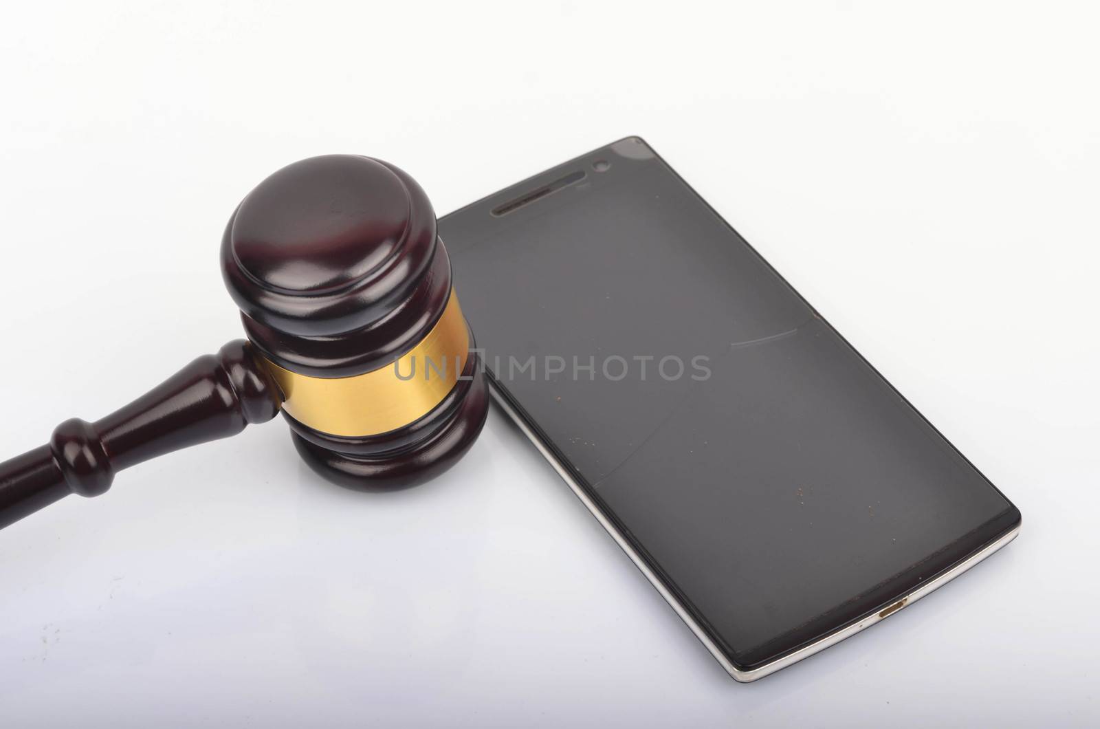 Judge hammer or gavel with smartphone on white background. Justice and law concept. Selective focus.