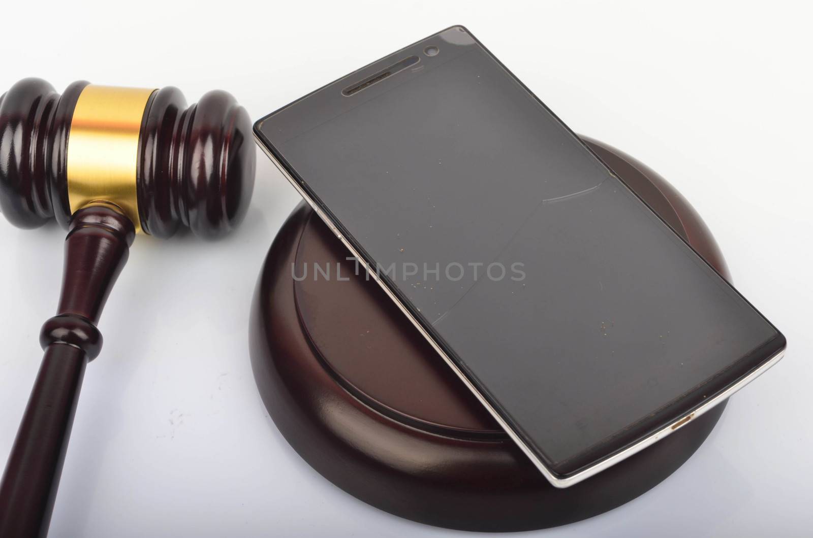 Judge hammer or gavel with smartphone on white background. Justice and law concept. Selective focus.