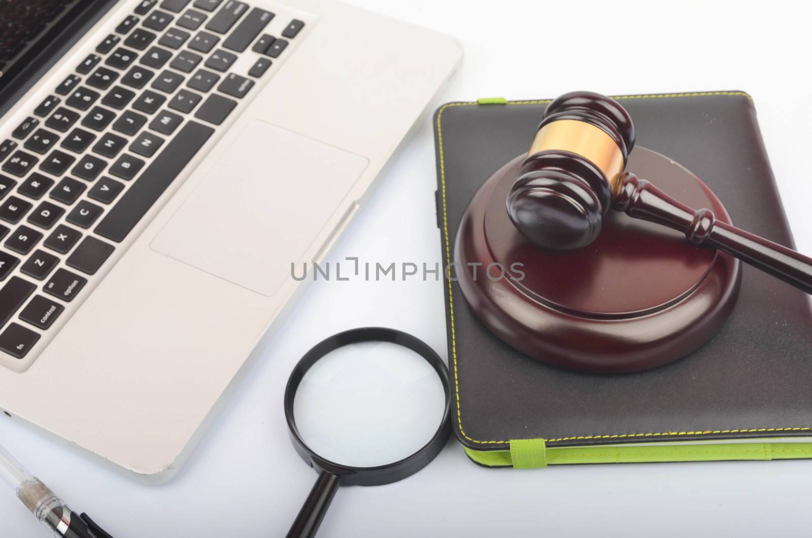 Cyber crime concept. Judge hammer or gavel with laptop on white background. Selective focus.