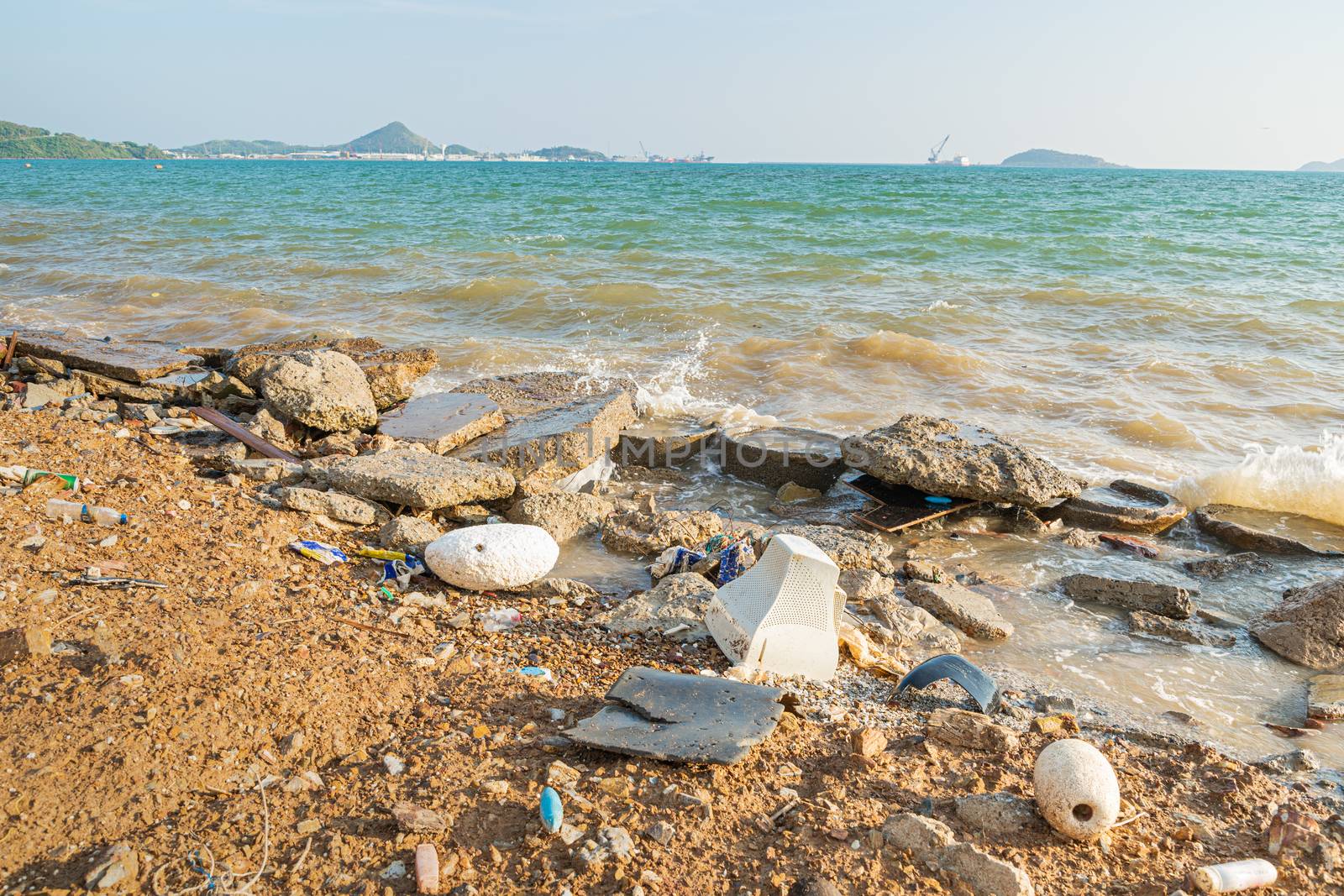 Electronic waste and foam become garbage on the beaches and birty sea water near the pier is a problem and pollution in Chonburi, Thailand