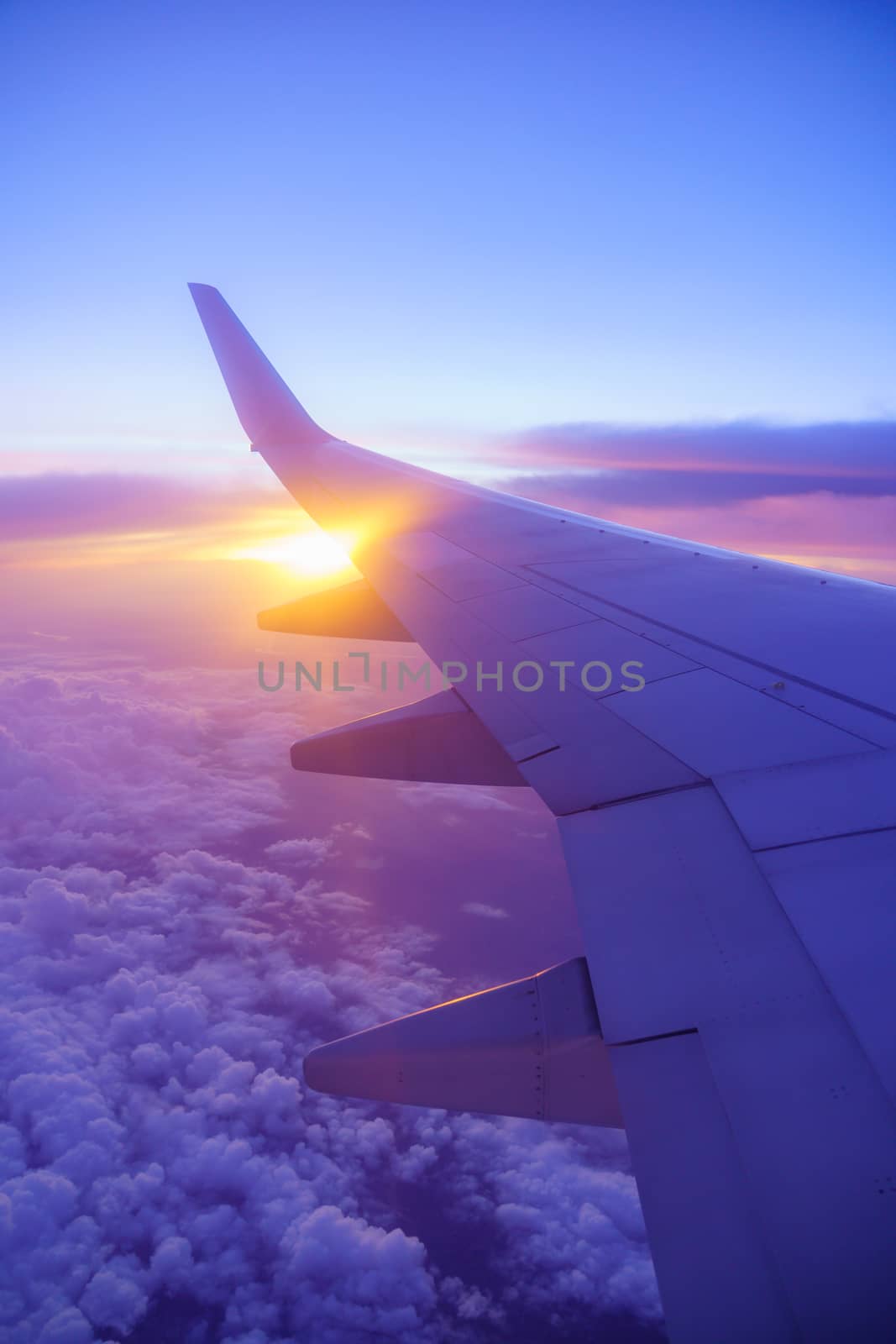 Beautiful sunset, sky on the top view, airplane flying view from inside window and cloud, sun down background aircraft of Traveling.