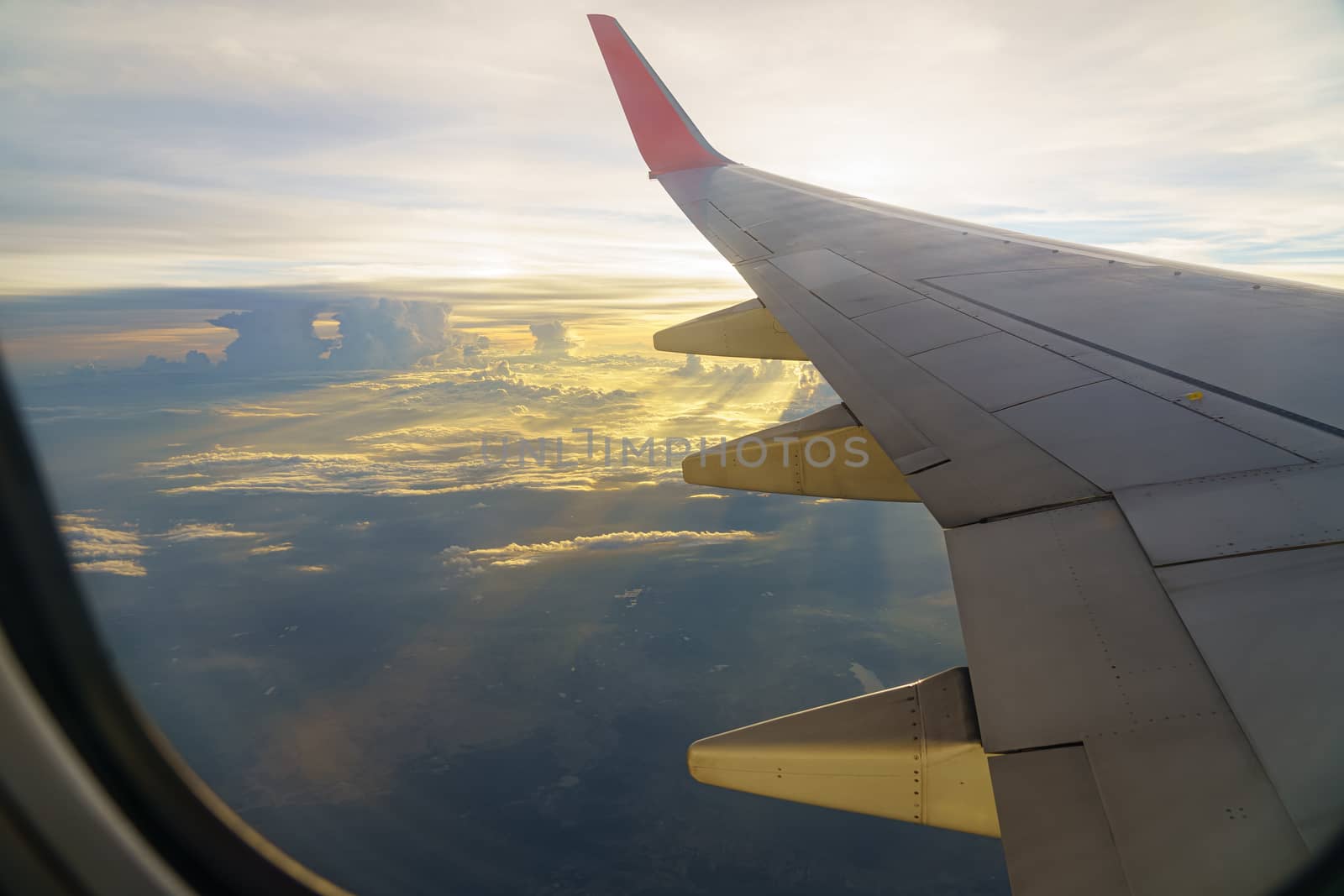 Beautiful sunset, sky on the top view, airplane flying view from inside window aircraft of traveling to travel alone onely time.