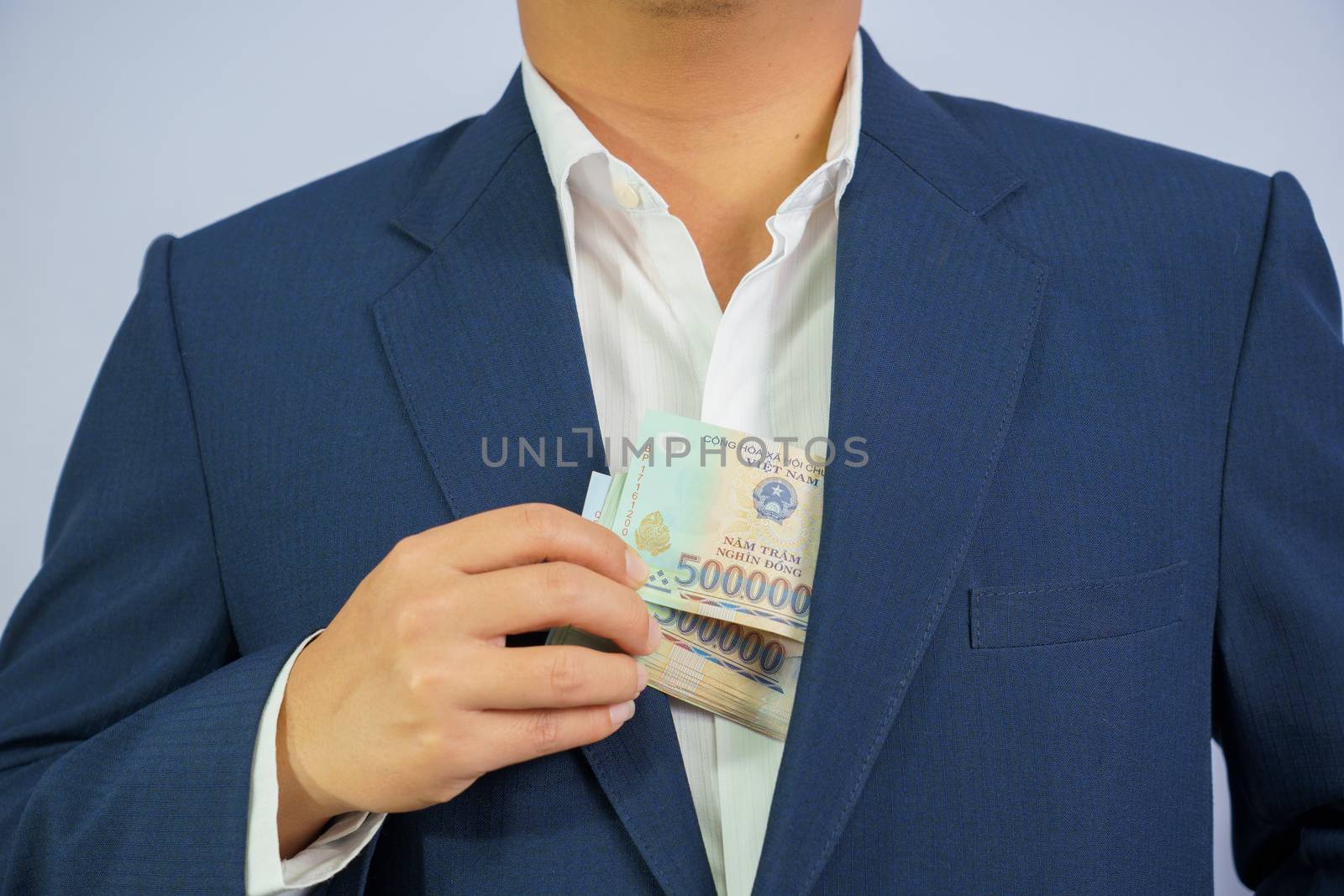 Money in Vietnam hold on hand business man wearing a blue suit (Socialist Republic Of Vietnam), Dong, VND, Pay, exchange money vietnamese on white background.