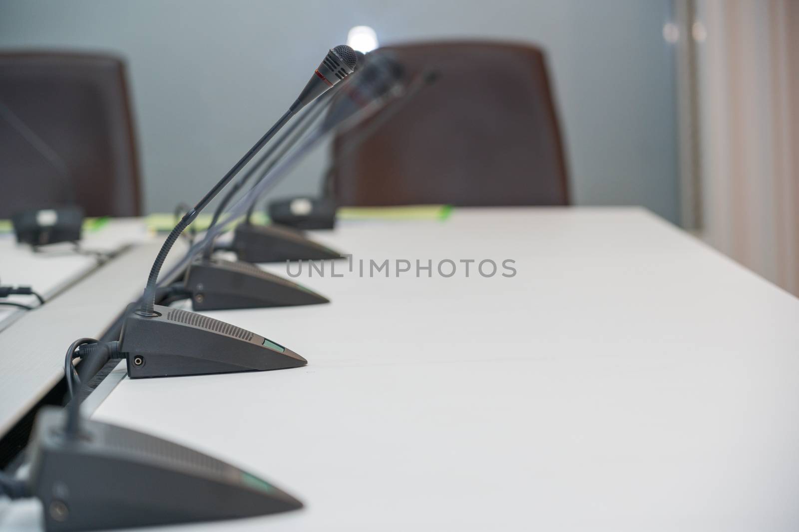 Soft and select focus Conferrence System chairman, delegate unit many microphone in the white business meeting room desk office table of the workplace.