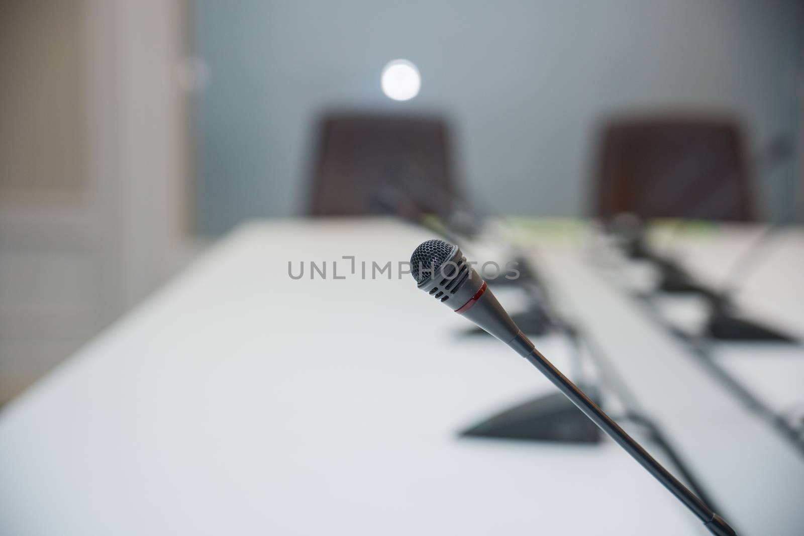 Soft and select focus Conferrence System chairman, delegate unit many microphone in the white business meeting room desk office table of the workplace.