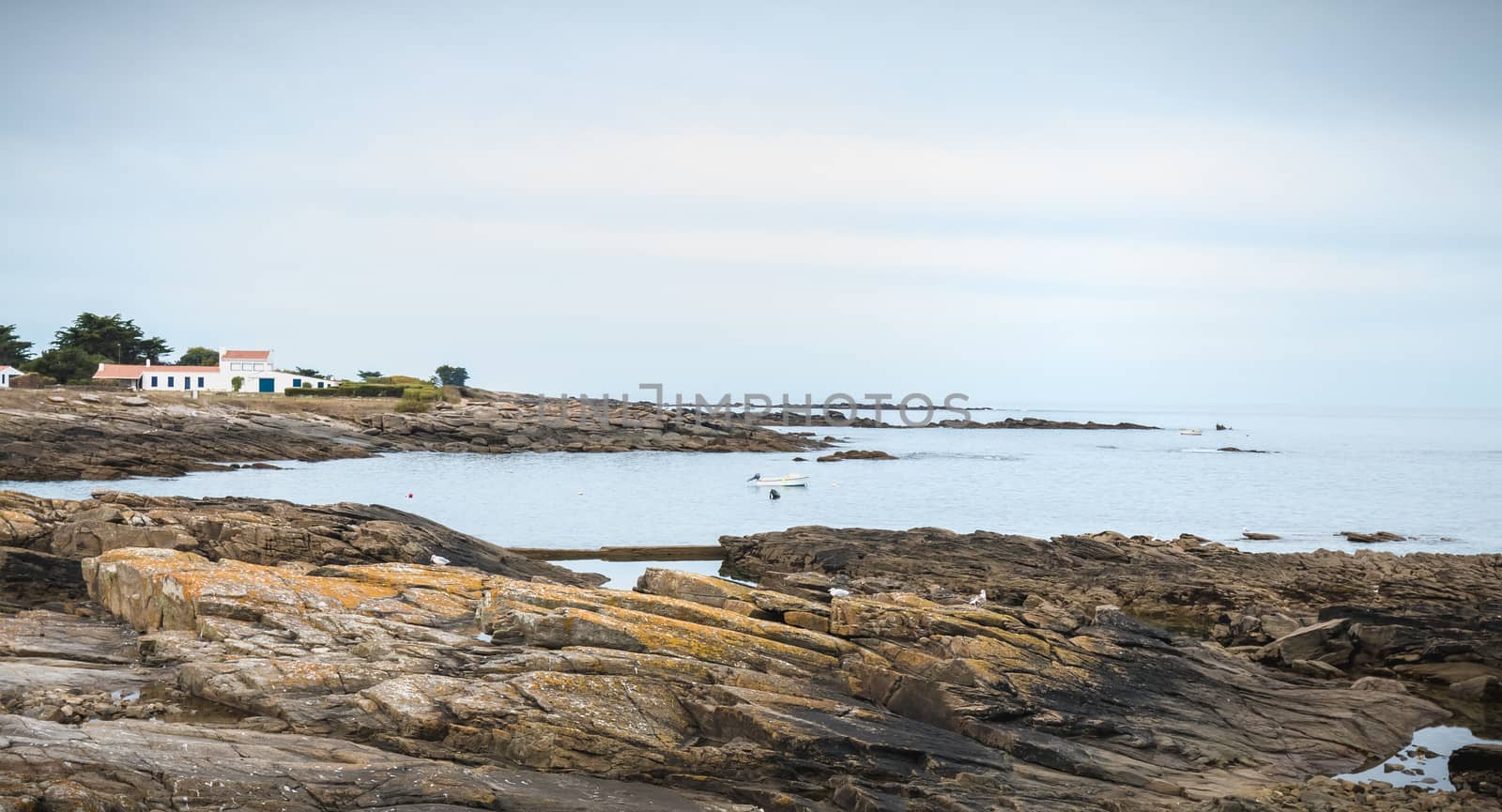 Yeu Island, France - September 16, 2018: Small pleasure boat parked between the rocks on a summer day