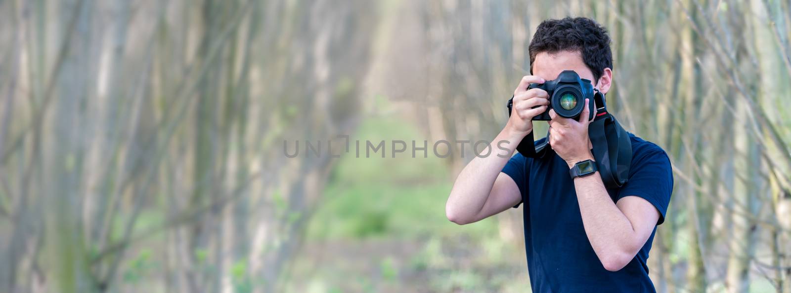 young man photographer in nature. copy space. banner by Edophoto
