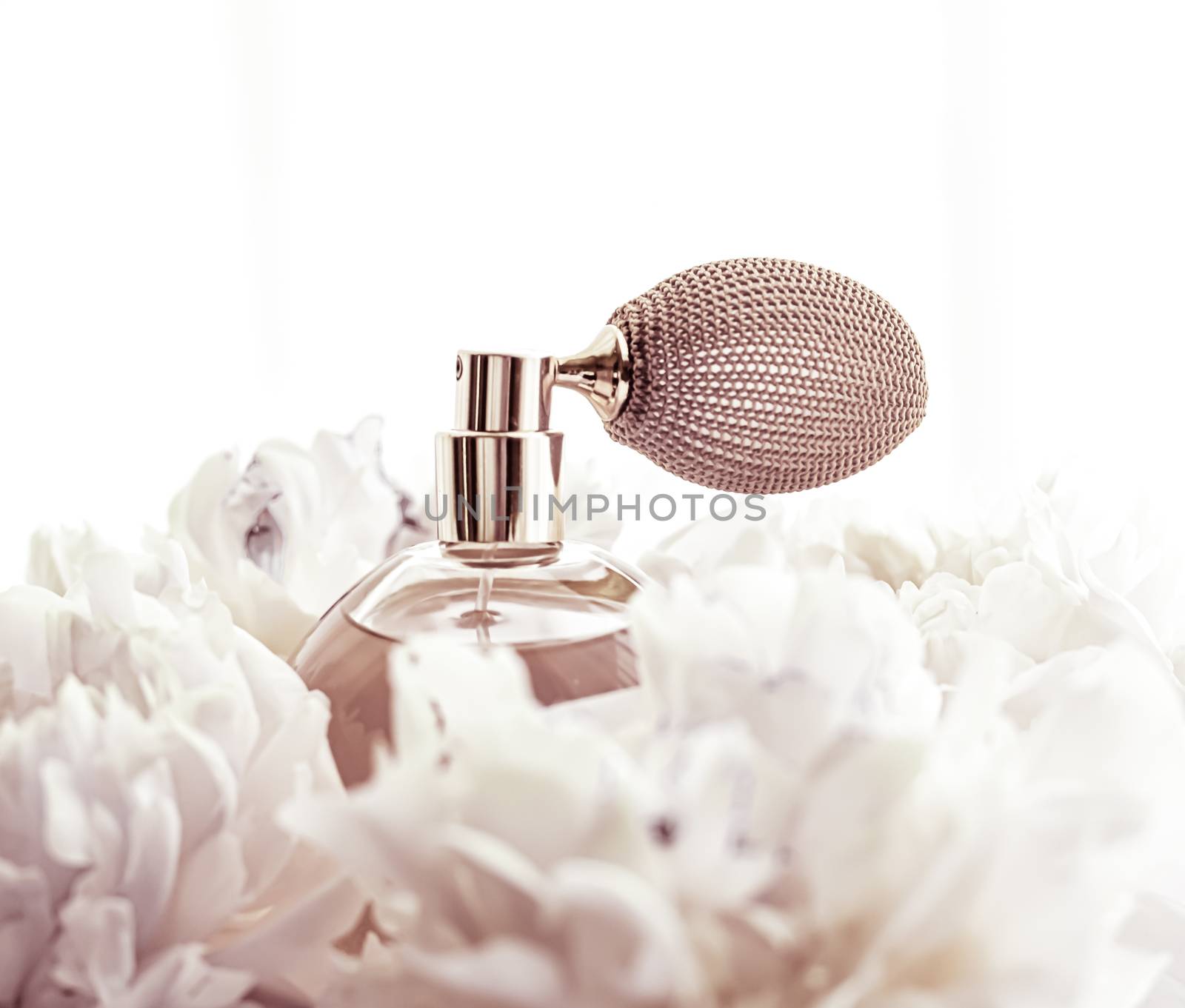 Retro fragrance bottle as luxury perfume product on background of peony flowers, parfum ad and beauty branding design