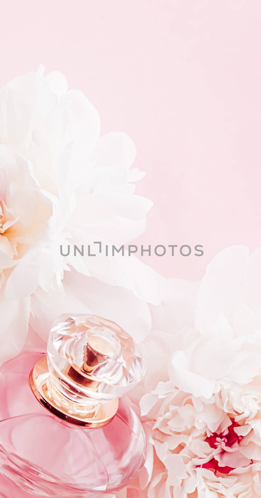 Luxe fragrance bottle as girly perfume product on background of peony flowers, parfum ad and beauty branding design