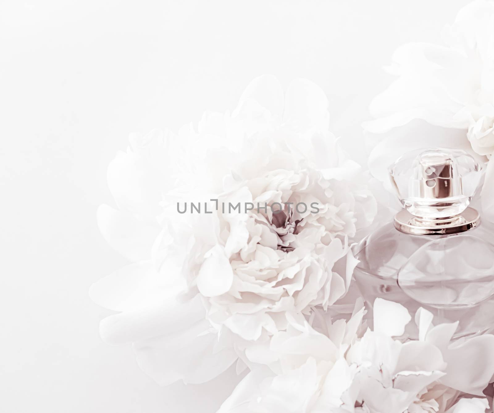 Chic fragrance bottle as luxe perfume product on background of peony flowers, parfum ad and beauty branding design