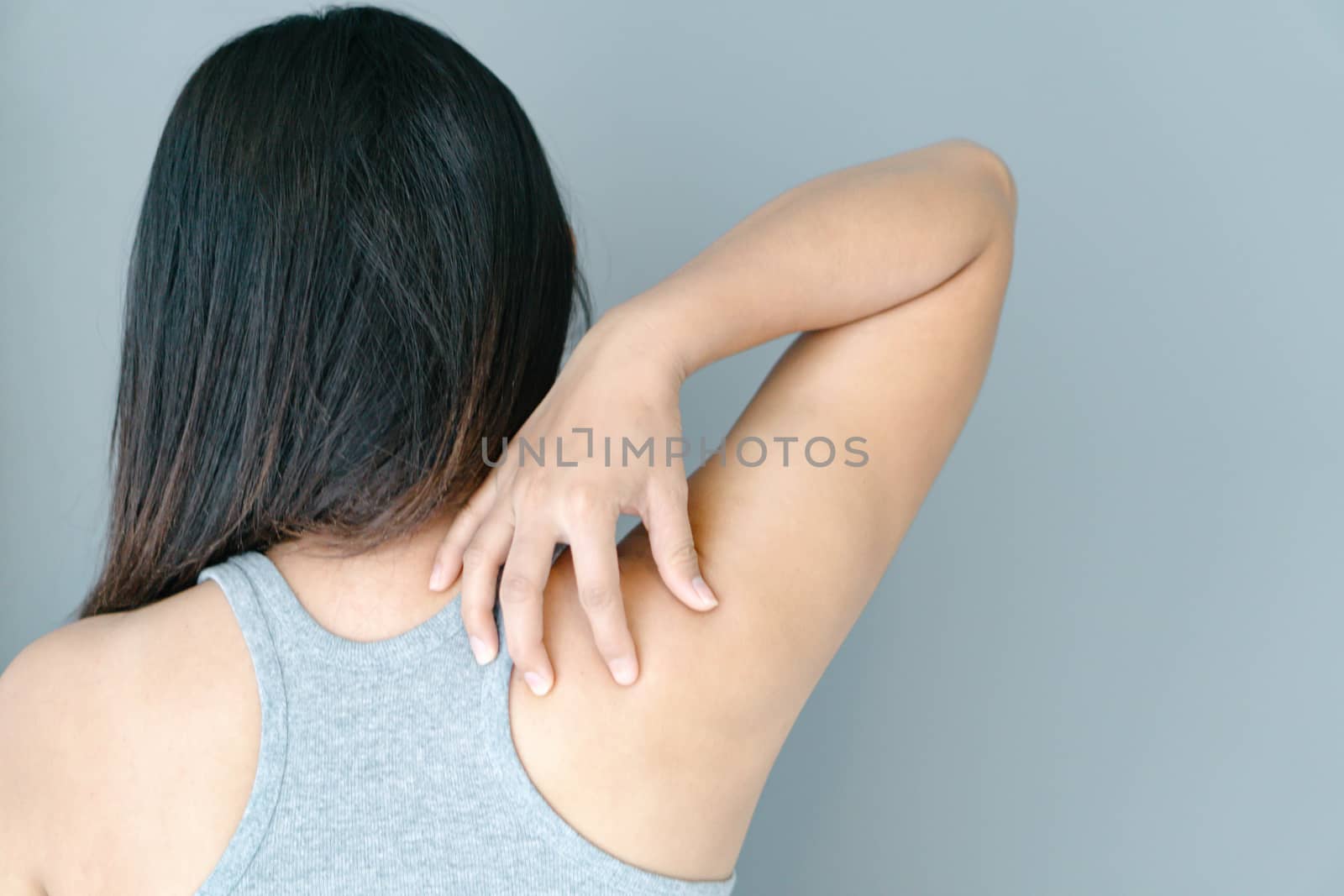 Closeup woman hand holding shoulder with pain on white background