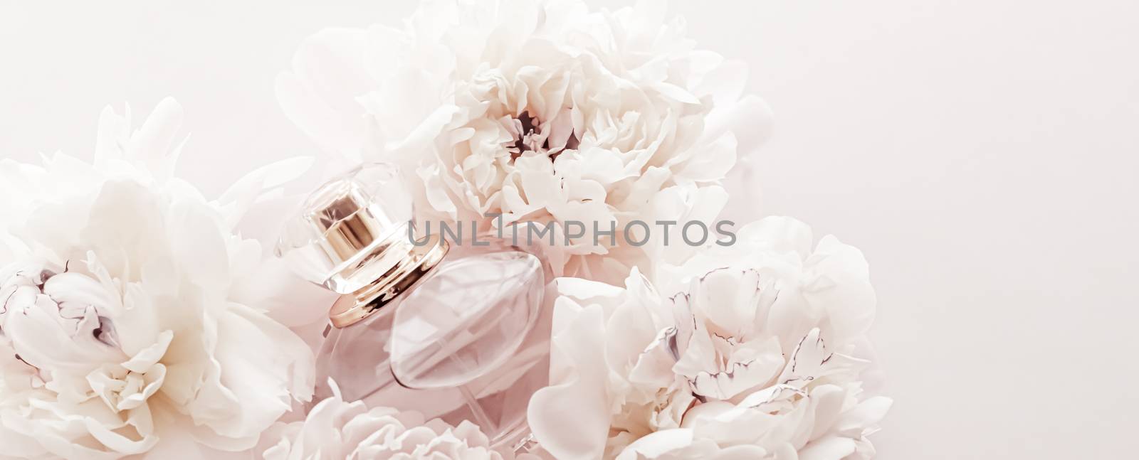 Fragrance bottle as luxury perfume product on background of peony flowers, parfum ad and beauty branding design