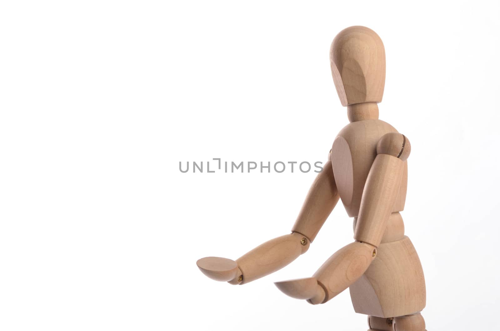 Wooden figure mannequin posing in action isolated on white background.