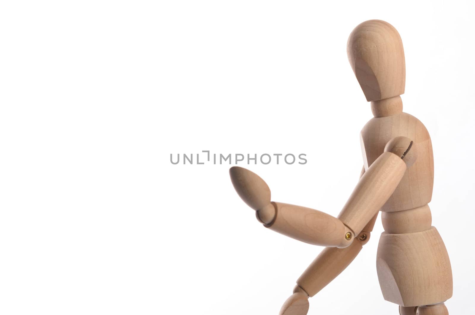 Wooden figure mannequin posing in action isolated on white background.