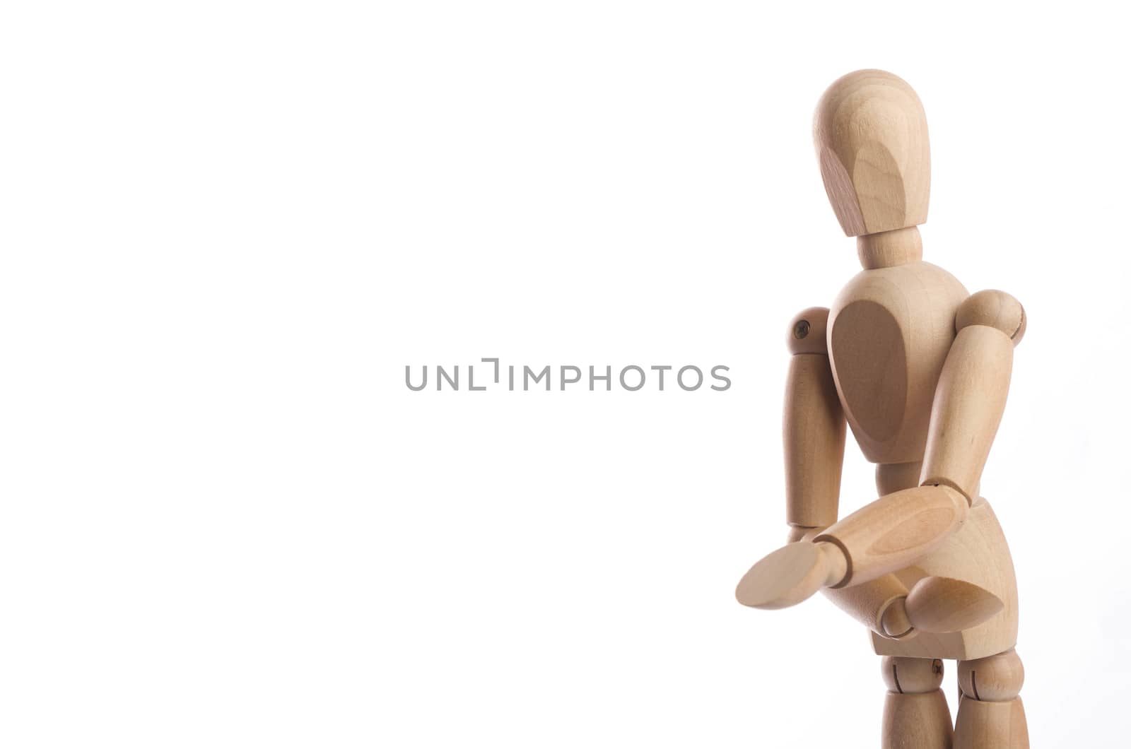 Wooden figure mannequin posing in action isolated on white background.