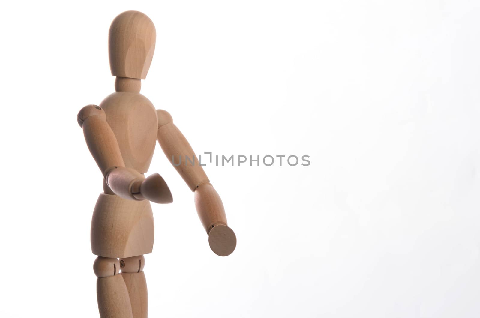 Wooden figure mannequin posing in action isolated on white background.
