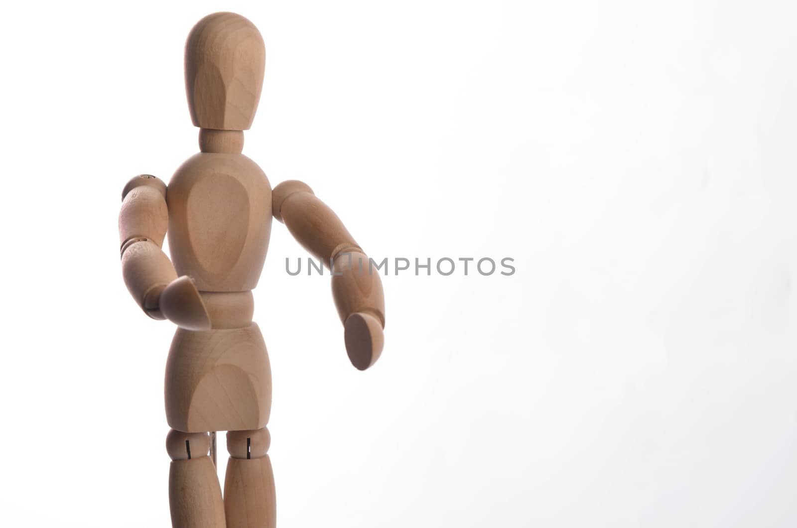 Wooden figure mannequin posing in action isolated on white background.