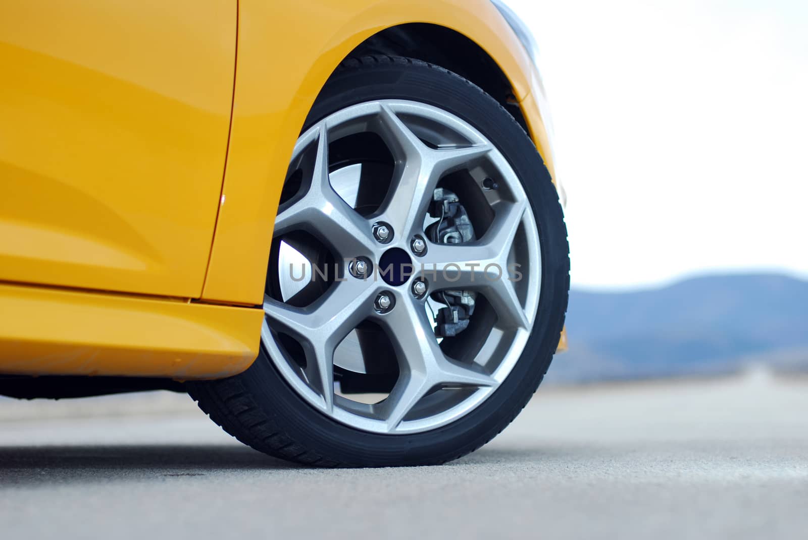 aluminum car wheel with a tire on a sports car